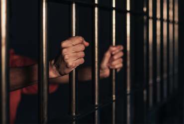 Hand gripping metal bars, Common Crimes: Felonies in New York